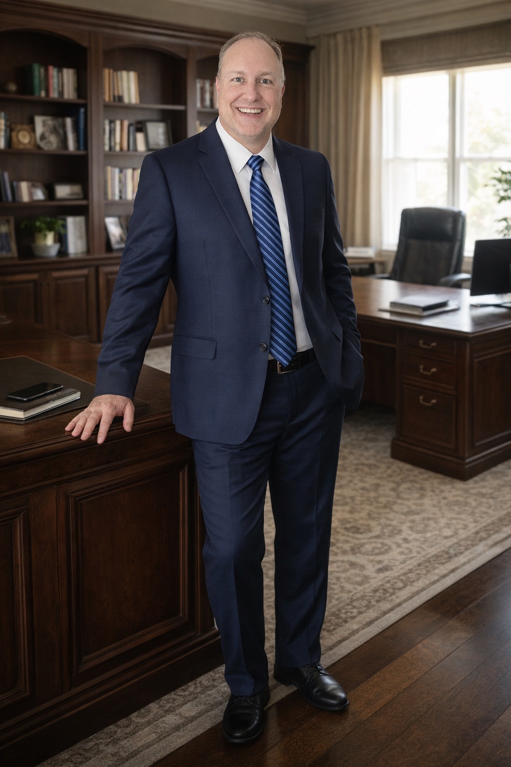 Willie Watkins standing in a business suit in an office